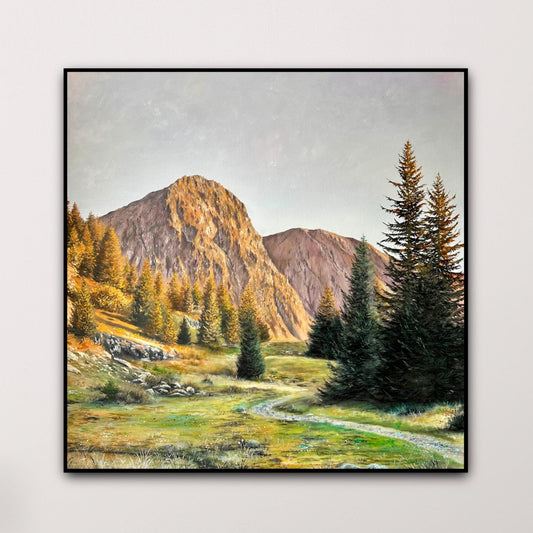 Wooden dresser with a landscape painting of mountains and trees on a white wall.