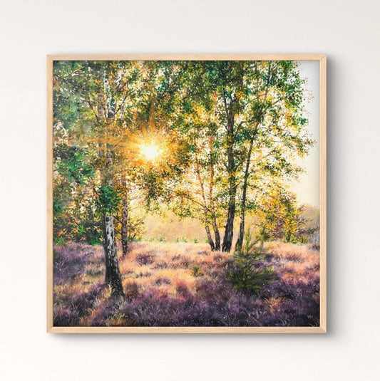 Framed artwork of a forest scene on a wall above a wooden table with a vase.